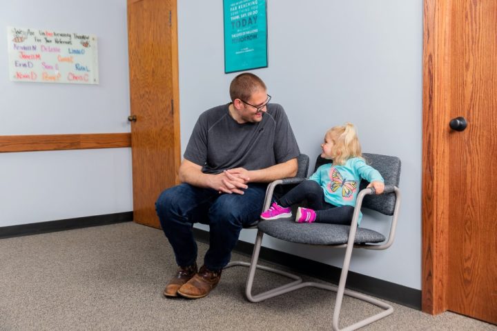 Father and daughter in waiting room