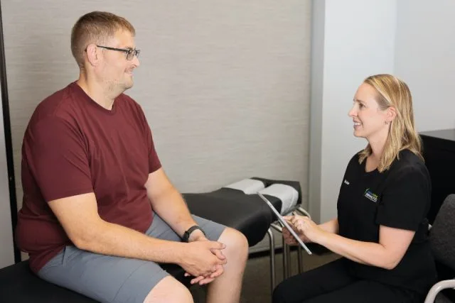 Dr. Acton consulting a patient