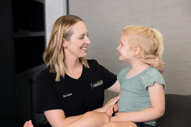 Dr. Acton smiling with a young girl